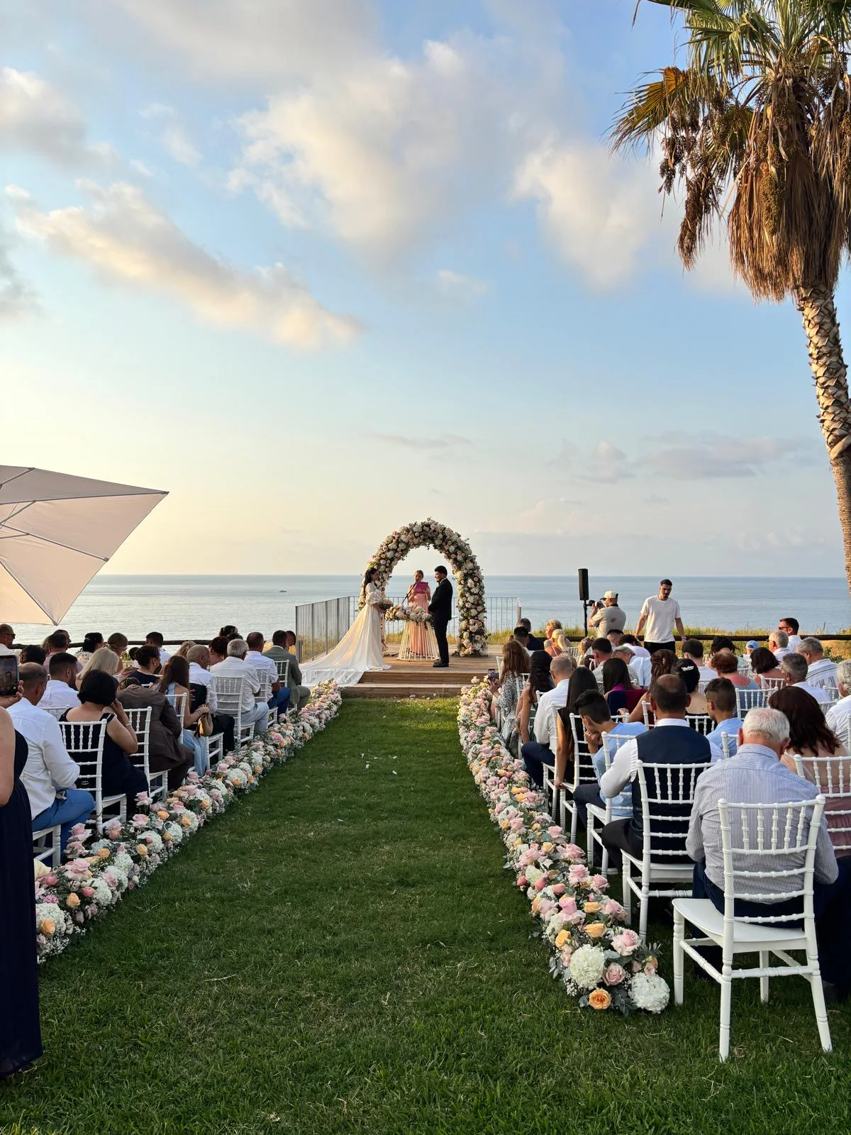 Seaside wedding ceremony at sunset